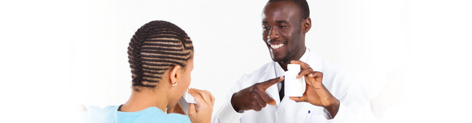 male pharmacist pointing at a bottle of medicine