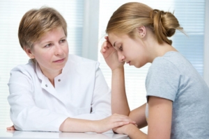young girl having a conversation with a therapist
